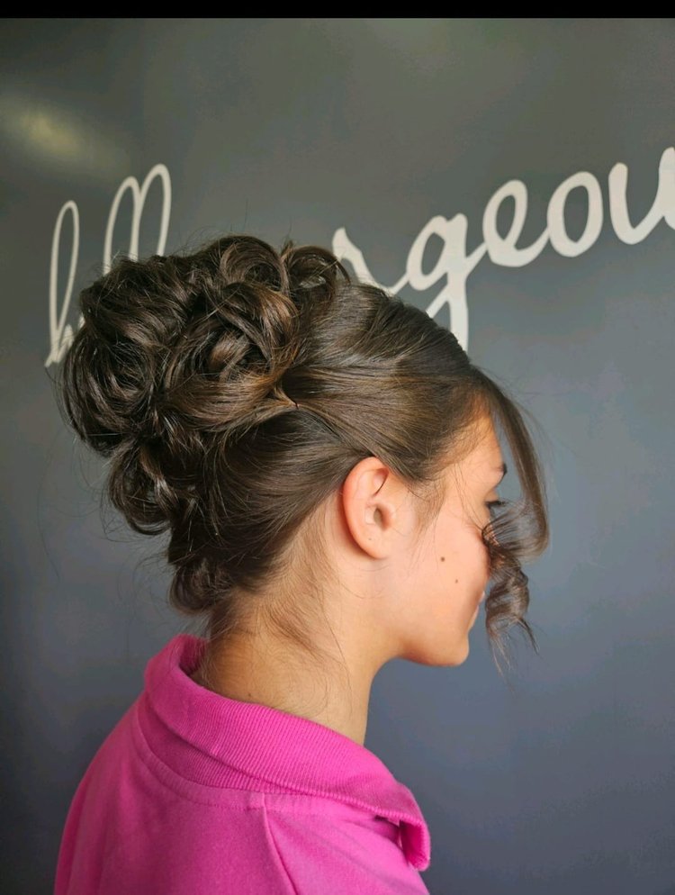 Side view of a woman after Addi gave her an updo.