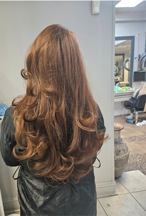 A woman after Addi gave her hair a blowout.
