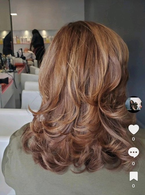 A woman after Addi gave her hair a blowout.