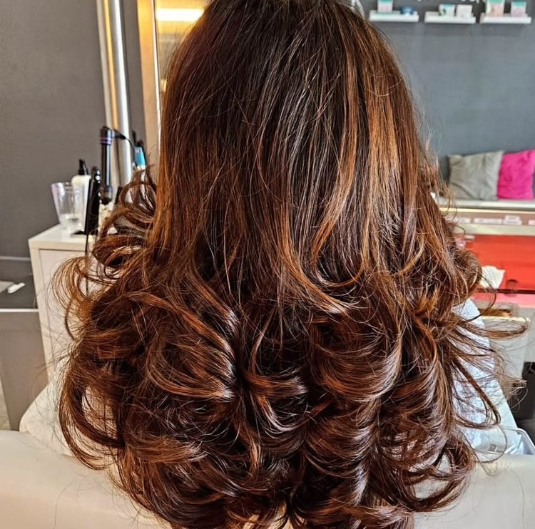 A woman after Addi colored her hair and gave a blowout.